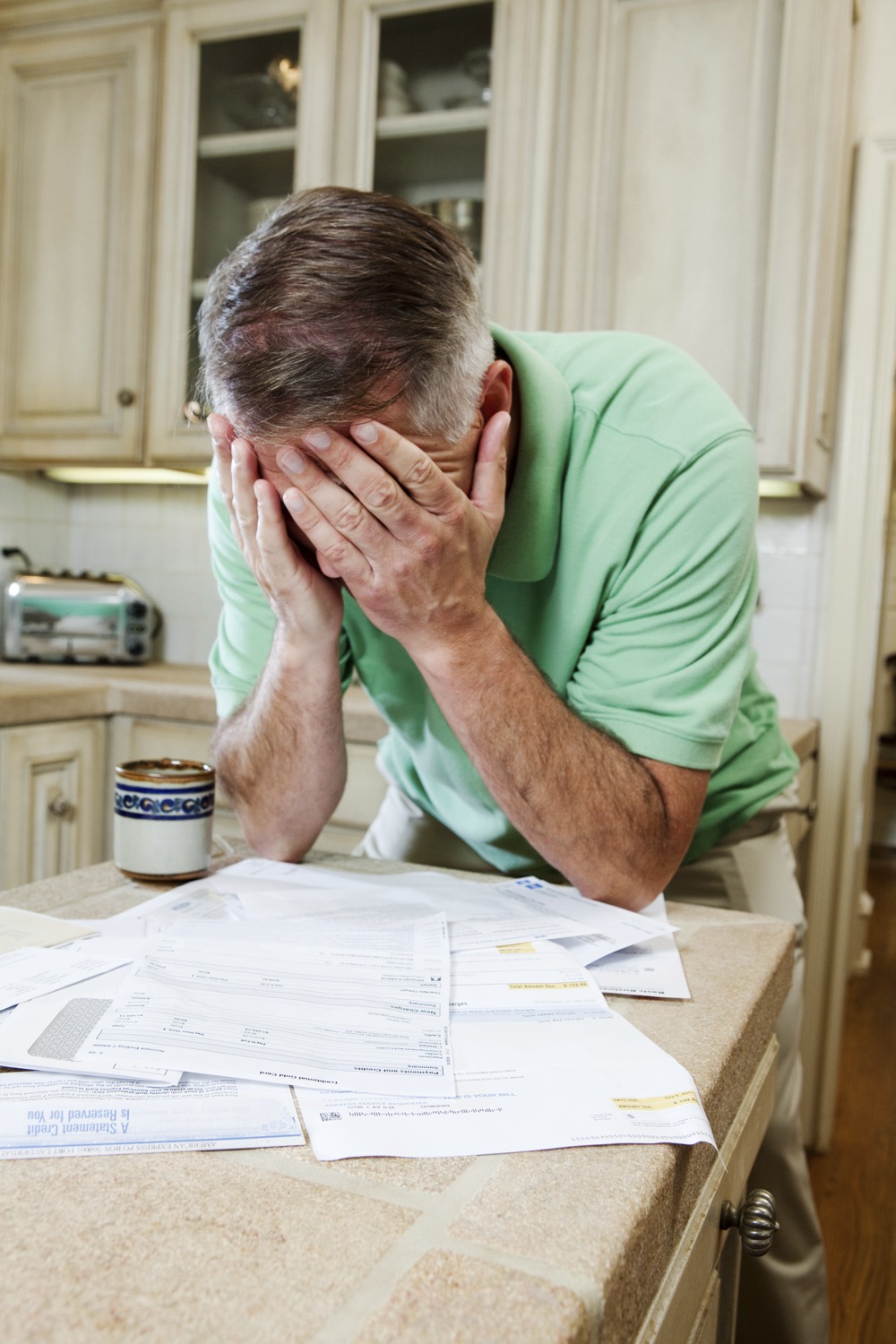 mature man with head in hands over table of househ 2024 05 29 03 44 01 utc